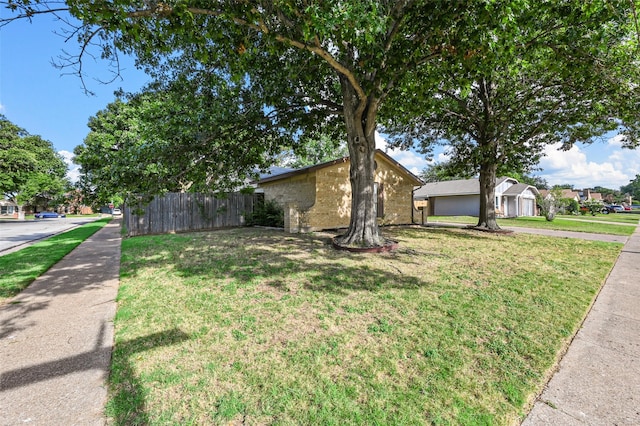 view of front facade featuring a garage and a front lawn