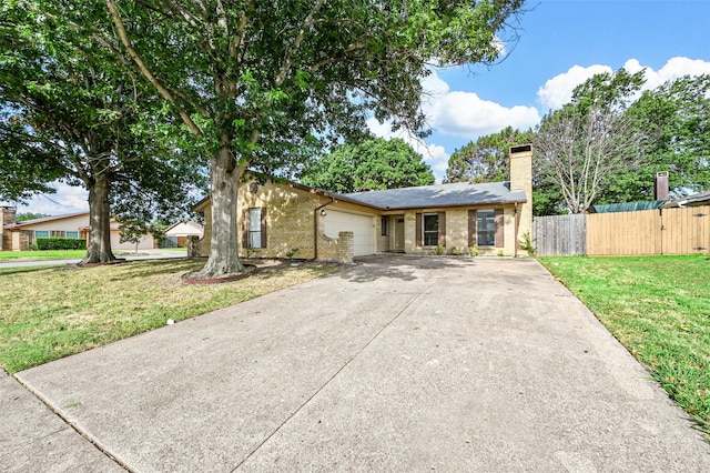 view of front of property featuring a front lawn and a garage