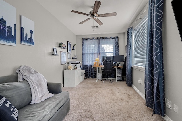 carpeted home office featuring ceiling fan