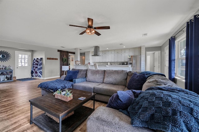 living room featuring ceiling fan and hardwood / wood-style floors