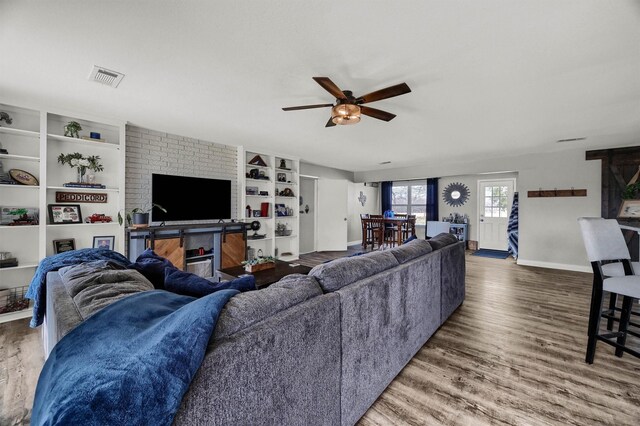 living room featuring ceiling fan and wood-type flooring