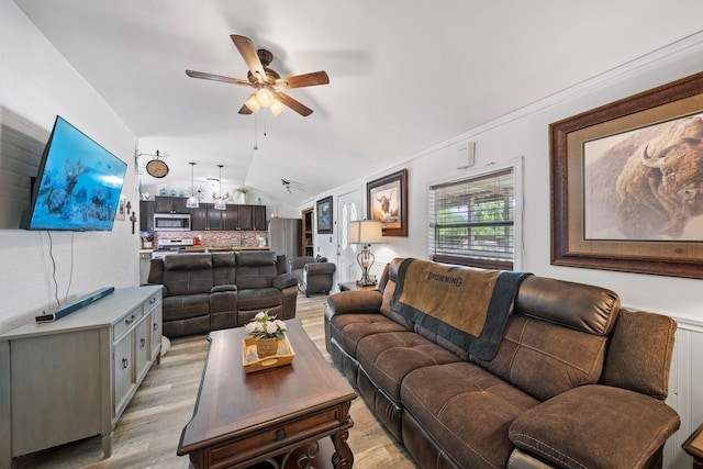 living area with light wood-type flooring, ceiling fan, and vaulted ceiling