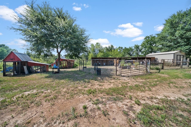 view of yard with an outbuilding and fence