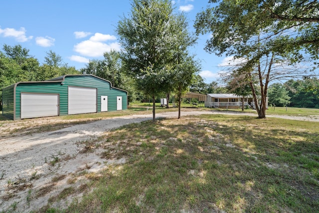 view of yard with an outbuilding and a garage