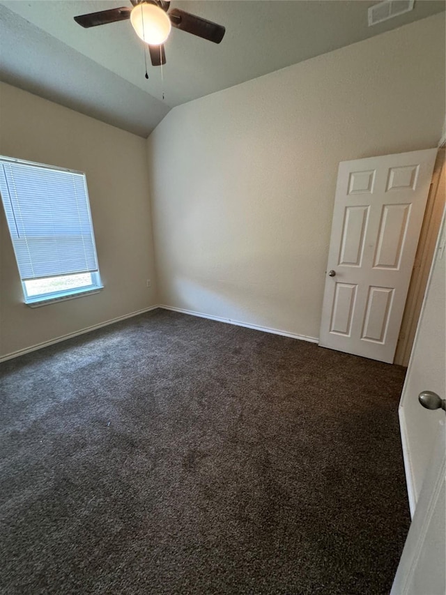 carpeted empty room with lofted ceiling and ceiling fan