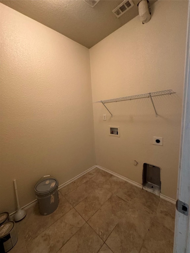 laundry area with gas dryer hookup, washer hookup, a textured ceiling, tile patterned floors, and hookup for an electric dryer