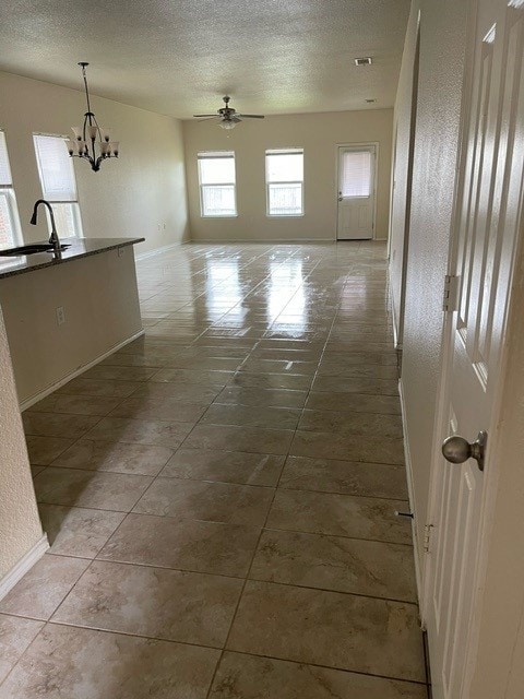 interior space featuring light tile patterned flooring, sink, and a notable chandelier