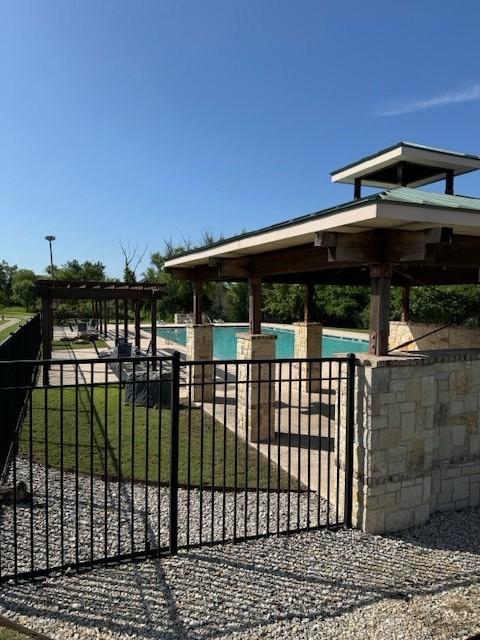 view of gate with a community pool