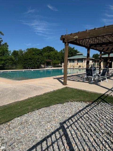 view of swimming pool featuring a pergola and a patio area