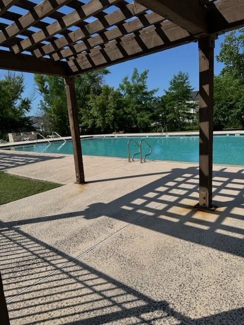 view of swimming pool featuring a pergola