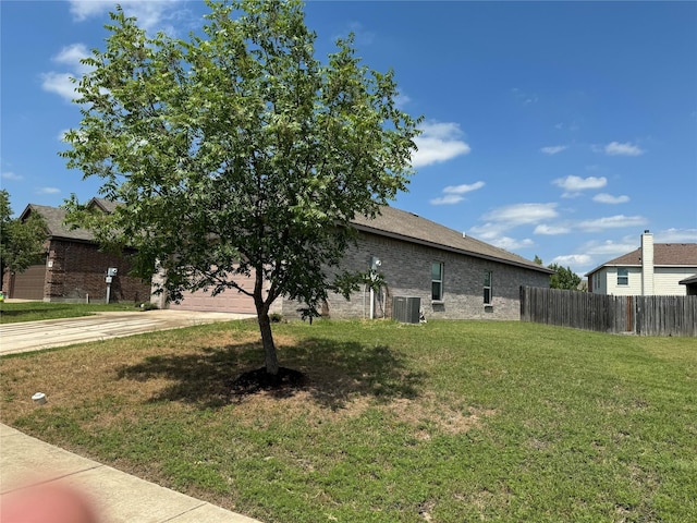 exterior space with cooling unit and a garage