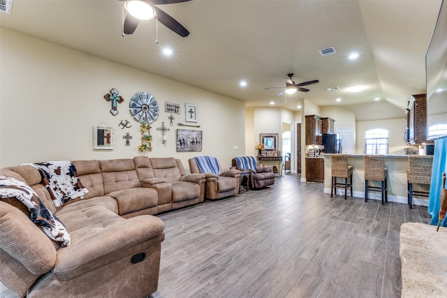 living room with wood-type flooring and ceiling fan