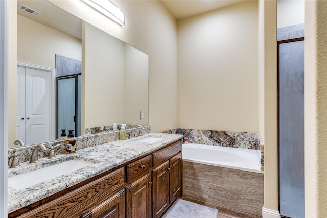 bathroom featuring vanity and shower with separate bathtub