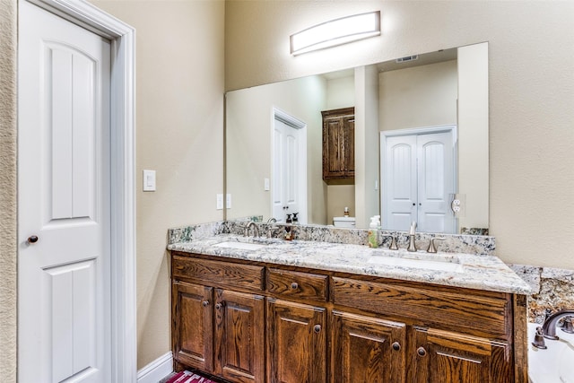 bathroom with vanity and toilet