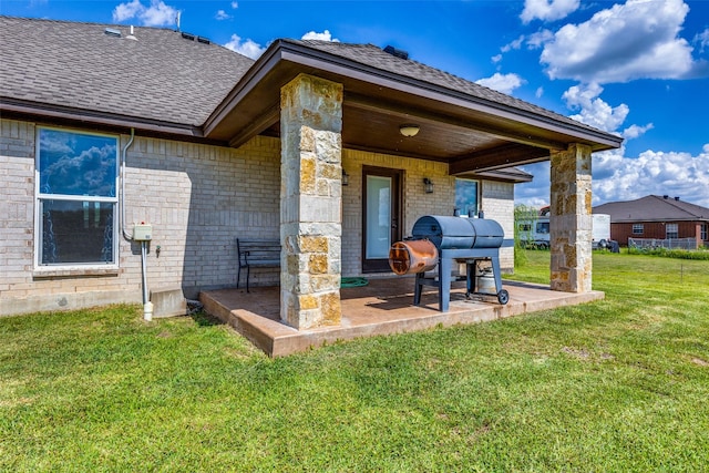 back of house with a yard and a patio