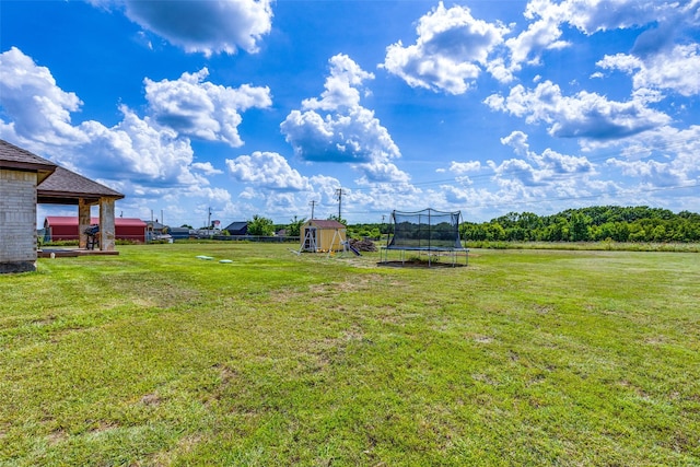 view of yard with a trampoline