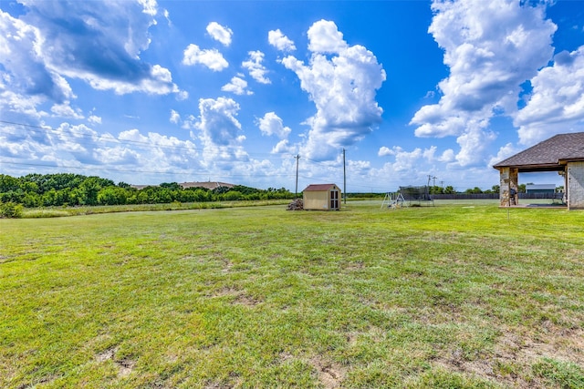 view of yard with a trampoline and a storage shed