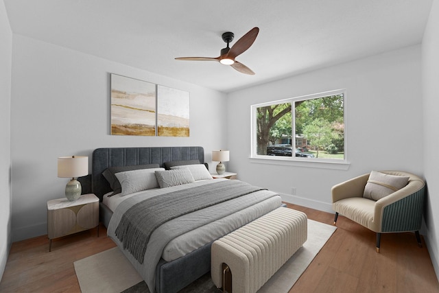 bedroom with ceiling fan and light hardwood / wood-style floors