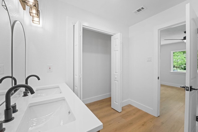 bathroom with ceiling fan, wood-type flooring, and vanity