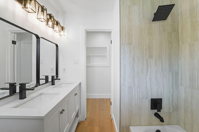 bathroom featuring vanity, shower / washtub combination, and hardwood / wood-style floors