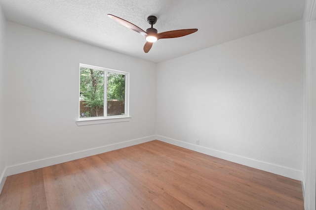 empty room with ceiling fan and wood-type flooring