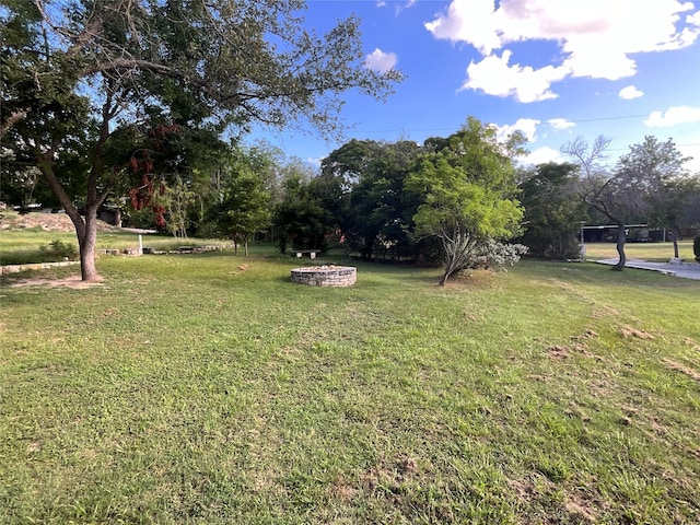 view of yard with an outdoor fire pit