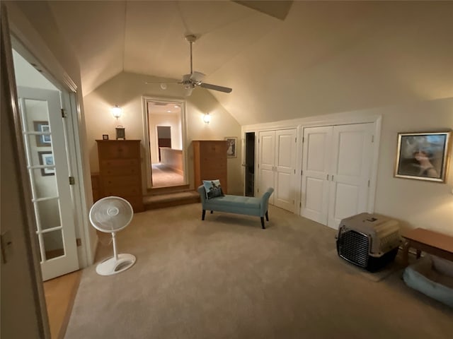 sitting room with carpet flooring, ceiling fan, and vaulted ceiling