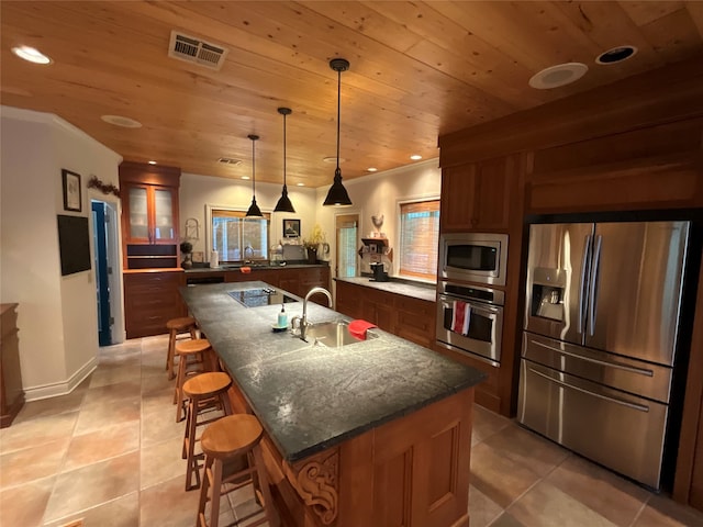 kitchen featuring a center island with sink, appliances with stainless steel finishes, sink, wood ceiling, and light tile floors