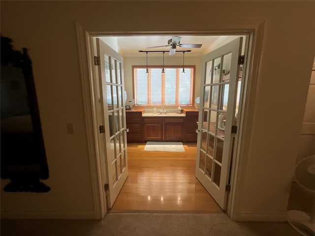 interior space featuring light carpet, sink, french doors, and crown molding