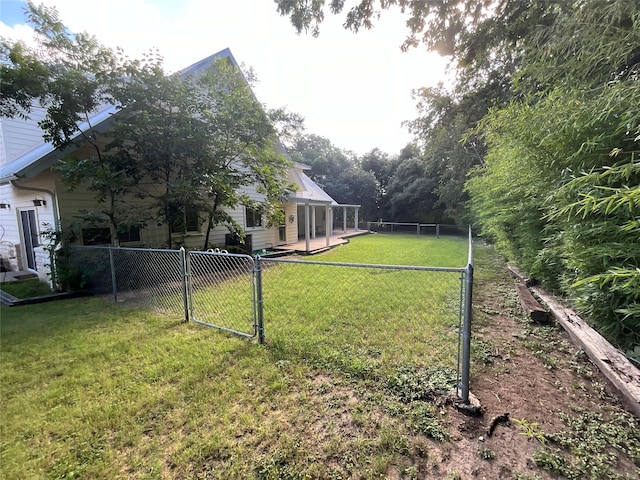view of yard featuring a gate and a fenced backyard
