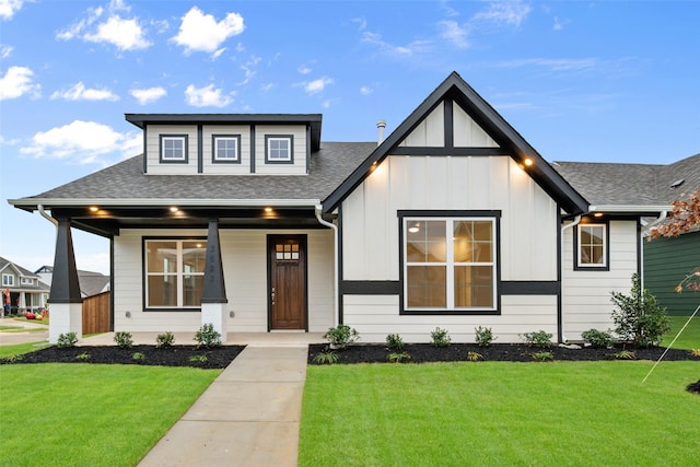 view of front of home featuring covered porch and a front yard