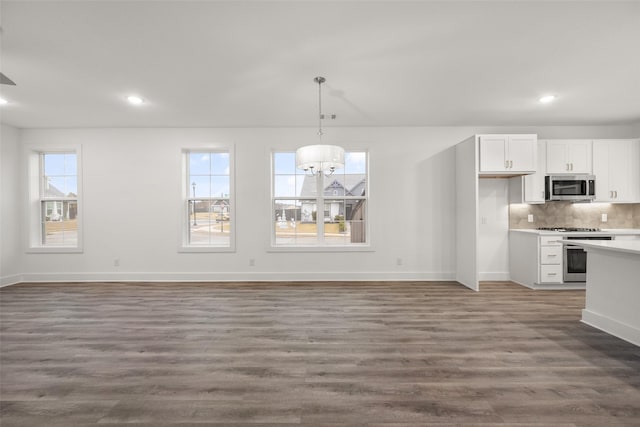 kitchen featuring white cabinetry, plenty of natural light, stainless steel appliances, and dark hardwood / wood-style floors