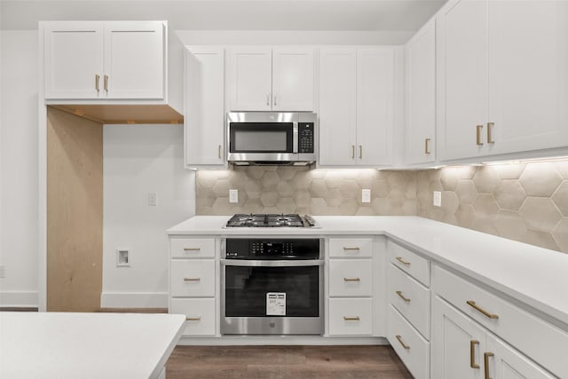 kitchen with decorative backsplash, dark wood-type flooring, white cabinets, and stainless steel appliances