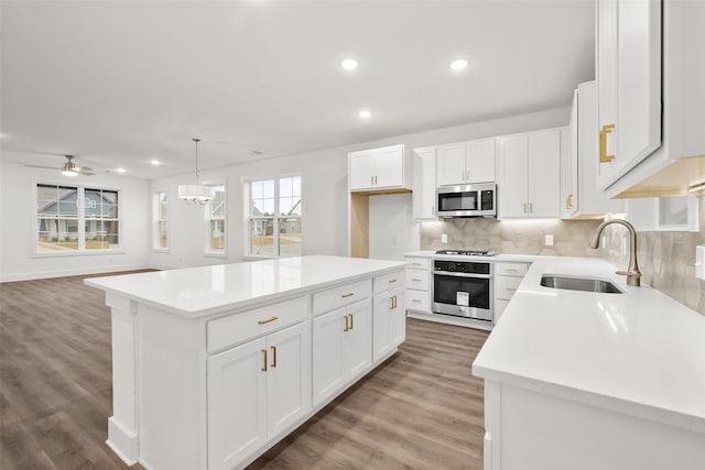 kitchen with white cabinetry, sink, a kitchen island, and stainless steel appliances