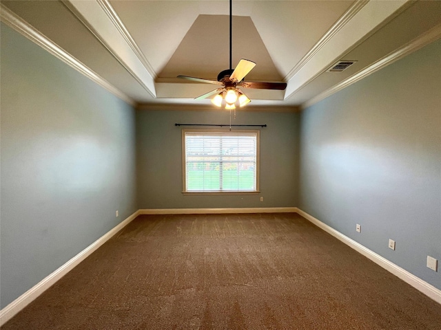 unfurnished room featuring crown molding, lofted ceiling, and a tray ceiling