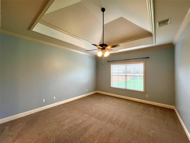 spare room with a raised ceiling, crown molding, carpet flooring, and ceiling fan