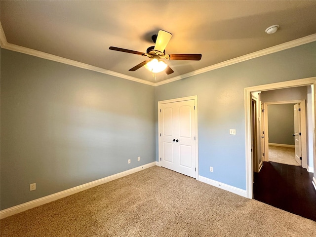 unfurnished bedroom featuring carpet floors, ornamental molding, and ceiling fan