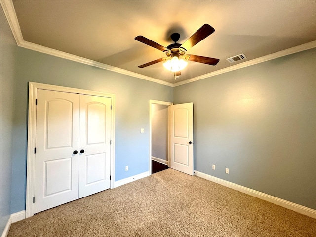 unfurnished bedroom with crown molding, carpet flooring, and ceiling fan