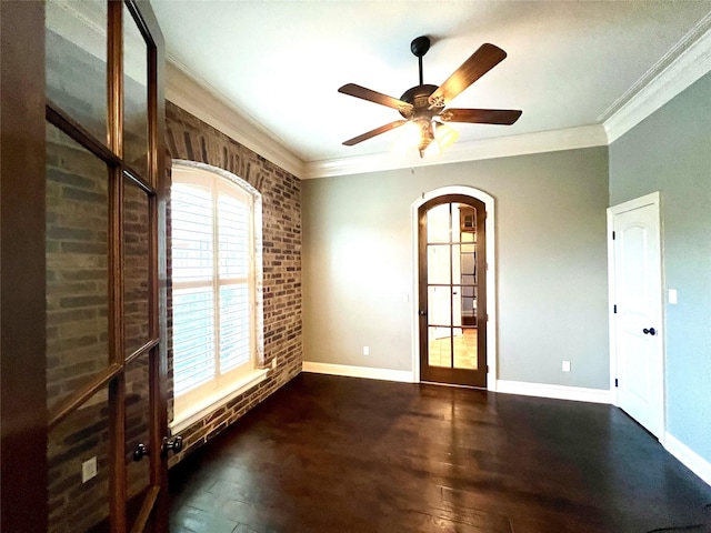 spare room featuring ornamental molding, dark hardwood / wood-style floors, ceiling fan, and french doors