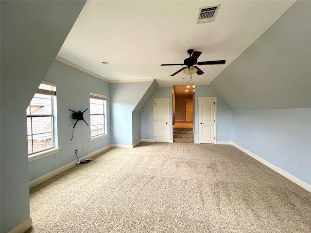 additional living space with lofted ceiling, light carpet, and ceiling fan