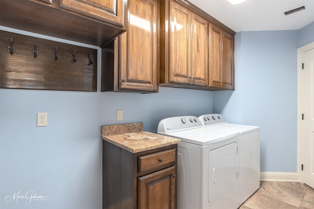 washroom with separate washer and dryer and cabinets