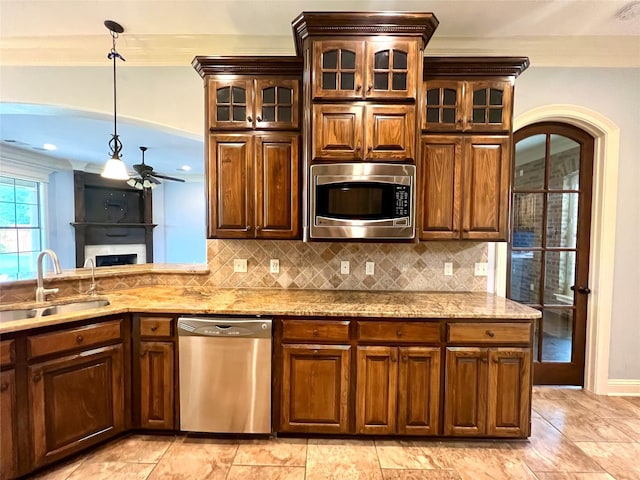 kitchen featuring tasteful backsplash, crown molding, appliances with stainless steel finishes, and sink