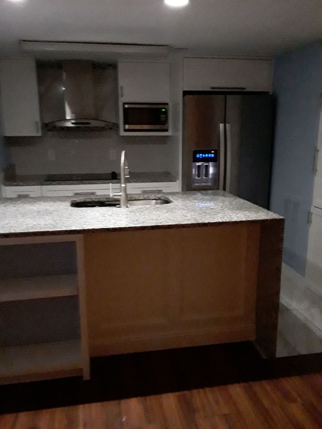 kitchen featuring wall chimney exhaust hood, dark wood-type flooring, and appliances with stainless steel finishes