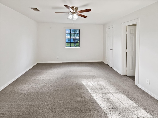 spare room featuring carpet floors and ceiling fan