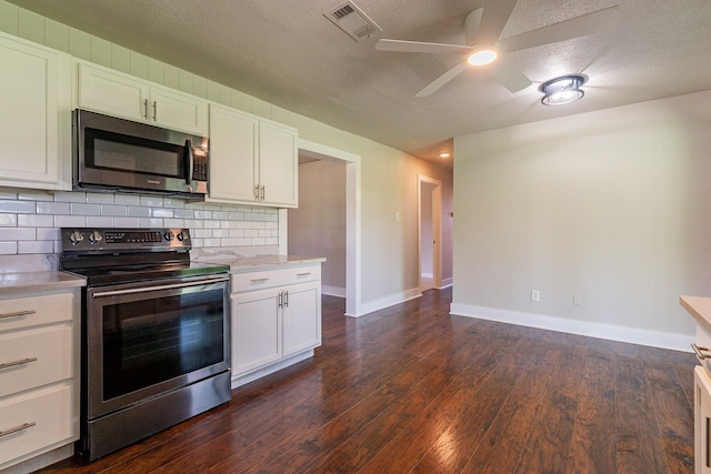 kitchen with a textured ceiling, white cabinetry, stainless steel appliances, decorative backsplash, and ceiling fan