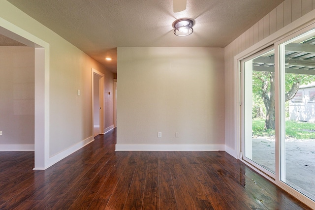 unfurnished room with plenty of natural light and dark hardwood / wood-style floors