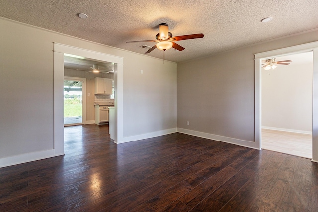 empty room with a textured ceiling, dark hardwood / wood-style floors, and ceiling fan