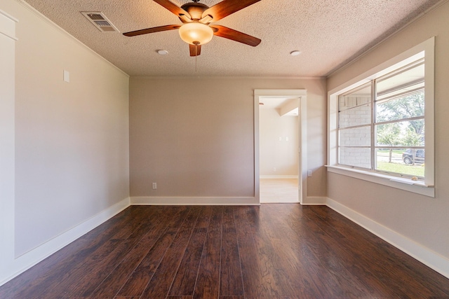 unfurnished room featuring ceiling fan, ornamental molding, dark wood-type flooring, and a textured ceiling