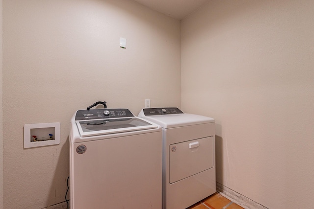 laundry room with light tile patterned floors and separate washer and dryer