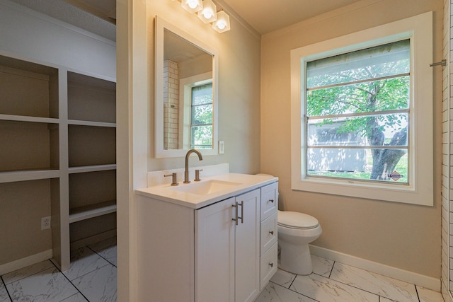 bathroom featuring toilet, vanity, and ornamental molding